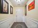 Inviting entryway with patterned rug, board and batten, guitar art, and a neutral door at 1252 Winding Path Rd, Lake Wylie, SC 29710