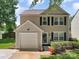 Charming two-story home with neutral siding, black shutters, an attached garage, and a well-maintained lawn at 1252 Winding Path Rd, Lake Wylie, SC 29710