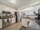 Bright kitchen features white cabinets, stainless steel appliances, granite countertops, and wood-look tile flooring at 1252 Winding Path Rd, Lake Wylie, SC 29710