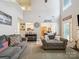 Bright, open living room with vaulted ceiling, gray sofas, and view into the dining room at 1252 Winding Path Rd, Lake Wylie, SC 29710