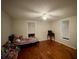 Bright bedroom with wood floors, ceiling fan, and natural light at 128 Pine St, Shelby, NC 28152