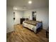 Bright bedroom features wood floors, neutral walls, and a queen-sized bed at 128 Pine St, Shelby, NC 28152