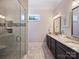 Beautiful bathroom features a glass-enclosed shower and double sink vanity with granite countertop at 1325 Kennon St, Charlotte, NC 28205