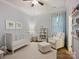 Comfortable Bedroom with a white crib, cozy chair, and natural light, creating a serene environment at 1325 Kennon St, Charlotte, NC 28205