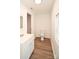 Bathroom with a modern vanity and toilet featuring hardwood floors and natural light at 1406 Caldwell St, Gastonia, NC 28052