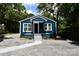 Charming blue home featuring new paint, white trim, covered entry and refreshed landscaping at 1406 Caldwell St, Gastonia, NC 28052