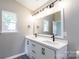 Bright bathroom boasts a double sink vanity, modern fixtures, and large mirror at 142 Single Oak Dr, Troutman, NC 28166