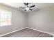 Bedroom with a ceiling fan, luxury vinyl floors, and large window at 142 Single Oak Dr, Troutman, NC 28166