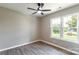 Bedroom with a ceiling fan, luxury vinyl floors, and bright window at 142 Single Oak Dr, Troutman, NC 28166