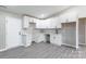 Bright kitchen features white cabinets, grey flooring and modern fixtures at 142 Single Oak Dr, Troutman, NC 28166
