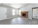 The living room features a brick fireplace, grey flooring, and natural light at 142 Single Oak Dr, Troutman, NC 28166