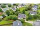 An aerial view shows a well-maintained home with mature trees and a fenced yard at 15248 Pangborn Pl, Charlotte, NC 28278