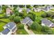 Aerial view of a charming home with lush landscaping, a long driveway and a fenced backyard at 15248 Pangborn Pl, Charlotte, NC 28278