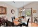 Cozy dining area with glass table, pendant lighting, and sliding glass door to the backyard at 15248 Pangborn Pl, Charlotte, NC 28278