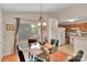 Cozy dining area with glass table, pendant lighting, and view into the kitchen area at 15248 Pangborn Pl, Charlotte, NC 28278