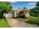 Lovely home with a one car garage, tidy landscaping, and inviting front porch with white railings at 15248 Pangborn Pl, Charlotte, NC 28278