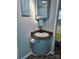A cute, compact bathroom features a corner sink, toilet paper holder, a framed mirror and storage at 166 Eagle Dr, New London, NC 28127