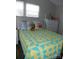 Bedroom with a decorative bedspread, dresser, and two large windows at 166 Eagle Dr, New London, NC 28127