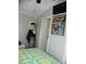 Bedroom with a mounted flat screen TV, comic book art and decorative clothing at 166 Eagle Dr, New London, NC 28127