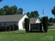 Bodin Shores Chapel featuring a steeple and well-maintained lawn with signage at 166 Eagle Dr, New London, NC 28127