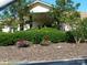 Clubhouse entrance with landscaped flowerbeds, a garden and covered entrance at 166 Eagle Dr, New London, NC 28127