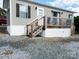Exterior view showing a manufactured home with a wooden deck and white trim at 166 Eagle Dr, New London, NC 28127