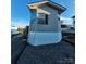 Exterior view showing a side of a manufactured home with blue sky backdrop at 166 Eagle Dr, New London, NC 28127