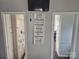 A hallway leads to the bathroom with a floral shower curtain and built-in shelving at 166 Eagle Dr, New London, NC 28127