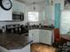 Bright kitchen features updated appliances, stylish countertops, and modern cabinetry with a cozy dining nook at 166 Eagle Dr, New London, NC 28127