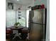 Well-lit kitchen with stainless steel refrigerator, wooden table near windows, and ample natural light at 166 Eagle Dr, New London, NC 28127