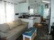 Inviting living space with a comfortable couch, stylish coffee table, and an open view of the kitchen area at 166 Eagle Dr, New London, NC 28127