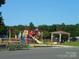 Community playground with colorful equipment, a gazebo, and mature trees at 166 Eagle Dr, New London, NC 28127