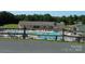 Community pool featuring lounge chairs, umbrellas, and surrounding trees at 166 Eagle Dr, New London, NC 28127