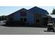 Restaurant building with signage, outdoor seating, and landscaping at 166 Eagle Dr, New London, NC 28127