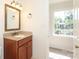 Bathroom with granite counters, wooden vanity, and natural light at 1928 Providence Rd, Charlotte, NC 28211