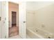 Bathroom with a soaking tub, neutral tile, and access to a large closet creates a relaxing, convenient space at 1928 Providence Rd, Charlotte, NC 28211