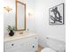 Bright bathroom featuring a vanity with white cabinets and a framed mirror at 1928 Providence Rd, Charlotte, NC 28211