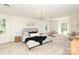 Spacious bedroom with neutral tones, large windows, stylish decor, and a comfortable seating area offers a serene retreat at 1928 Providence Rd, Charlotte, NC 28211