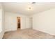 Spacious bedroom boasts neutral carpet, white walls, and access to an attached bathroom at 1928 Providence Rd, Charlotte, NC 28211