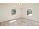 Bright bedroom with two large windows providing natural light and a view of the outdoors at 1928 Providence Rd, Charlotte, NC 28211