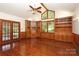 Spacious bonus room featuring wood paneling, built-in cabinets, and a vaulted ceiling at 1928 Providence Rd, Charlotte, NC 28211