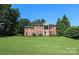 Charming brick home with a well-manicured lawn and classic architectural details at 1928 Providence Rd, Charlotte, NC 28211