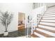 Bright foyer with a wooden staircase and decorative white railing at 1928 Providence Rd, Charlotte, NC 28211