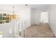 Hallway with a large chandelier, classic railing, and expansive windows offers a bright, airy feel at 1928 Providence Rd, Charlotte, NC 28211