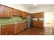 This kitchen features stainless steel appliances, wood cabinets, and green countertops at 1928 Providence Rd, Charlotte, NC 28211