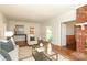 Light and bright living room with hardwood floors, chair, and decorative fireplace at 1928 Providence Rd, Charlotte, NC 28211
