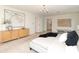 Generously sized main bedroom includes a chandelier, large artwork, and a glimpse into the ensuite bathroom at 1928 Providence Rd, Charlotte, NC 28211