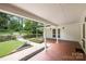 Inviting outdoor patio featuring brick flooring and a view of the well-maintained backyard and garden at 1928 Providence Rd, Charlotte, NC 28211