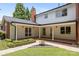 Rear exterior featuring a white siding home with covered patio and manicured lawn at 1928 Providence Rd, Charlotte, NC 28211