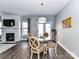 Charming dining room with a fireplace, hardwood floors, and natural light at 2003 Trigger Dr, Indian Trail, NC 28079